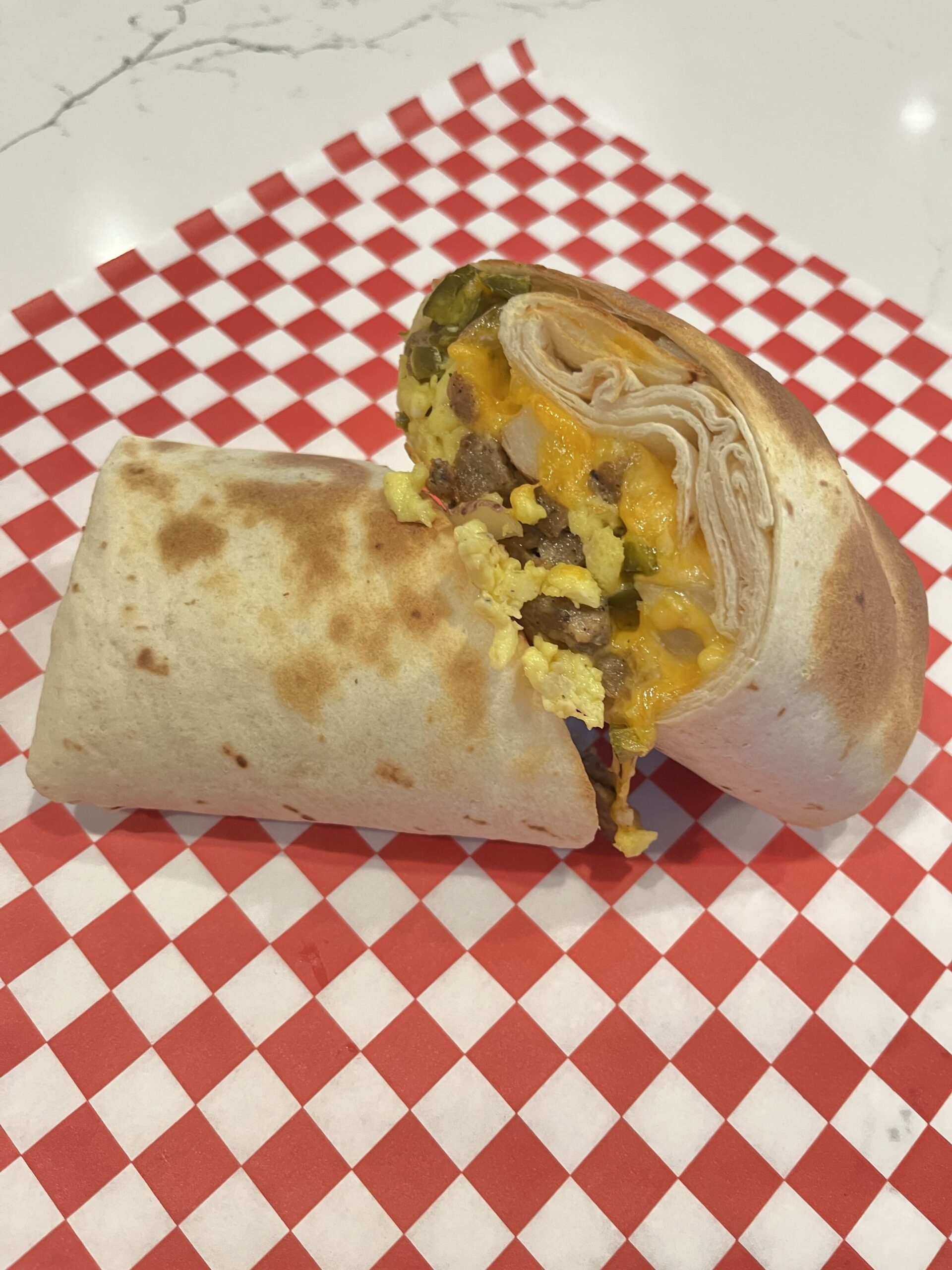breakfast burrito, sausage, eggs, melted cheese
